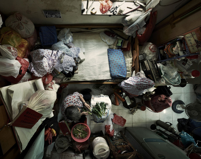 Editorial Use Only. No stock, books, advertising or merchandising without photographer's permission Mandatory Credit: Photo by Benny Lam/SoCO/Rex / Rex USA (1254664d) (Cropped picture) An elderly person living in urban slums in Hong Kong. Shocking aerial photos of cramped Hong Kong apartments, Hong Kong - 22 Feb 2013 FULL COPY: http://www.rexfeatures.com/nanolink/k4y9  For people living in the west, it's hard to imagine anyone living in an apartment this small. But for some of the poorest people in Hong Kong this is their home, all 40 square-foot of it.  The Society for Community Organisation (SoCO) has released a set of birds-eye images of low-income families, singletons, elderly and unemployed people living in urban slums to highlight the housing problem in Hong Kong. Director of SoCO, Ho Hei-Wah says: "By taking these photos of inadequate housing we have uncovered the problems and want to arouse public and government concern over the issue. "These people have to afford an expensive rent rate; it equals to approximately GBP 6-7.50 per square foot per month and sometimes have to wait years for public rental housing because they have so few in Hong Kong."